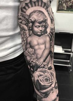 a man's arm with an angel and roses tattoo on it