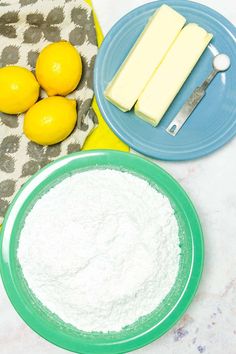 there are lemons and cheese on the table next to plates with cake batter in them