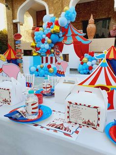 the table is set up with balloons, plates and napkins for dr seuss