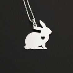 "Sterling Silver Bunny necklace Rabbit necklace ♣NOTE: All Pendant has a Heart- and Engraving is not Related to the heart - the heart is cutout ♣NOTE: if you don`t want a heart please mention it on your order Item Description : ♣ Material: Sterling Silver ♣ Thickens of Pendant : 22 Gauge (0.64 mm) ♣ Finish: Bright Satin Finish ♣ Size of the pendant : around 3/4 \" ♣ Chain Material: Sterling Silver Box Chain (Made in Italy) ♣ 16\"-18\"-20\" Chains Thickness is 0.8 mm ♣ 22\" inch Chain Thickness i Cute Silver Charm Necklace For Valentine's Day, Cute Sterling Silver Necklace Gift, Cute Sterling Silver Necklace For Gift, Cute Silver Charm Necklace With Heart Charm, Cute Silver Heart Necklace For Valentine's Day, Cute Sterling Silver Necklace For Birthday Gift, Silver Heart Charm Necklace For Birthday Gift, Birthday Sterling Silver Charm Necklace With Clavicle Chain, Dainty Silver Heart Necklace For Birthday Gift