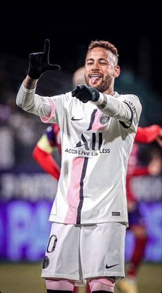 a soccer player holding his hand up in the air