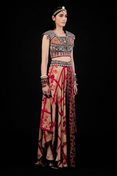 Multi color flared printed trouser with embellished waist band. Paired with multi color blouse, featuring exquisite embroidery, including resham thread work, mirror and beads.
Component: 2
Embroidered, Printed
Neckline: Square
Sleeve Length: Cap
Fabric: Kurta: Cotton; Trouser: Natural Crepe
Color: Multi Color, Red
Deep back neck with tassel tie-ups
Elasticated back waist band trouser
Asymmetric hem trouser
Note: The dupatta worn by the model is for styling purpose only - Aza Fashions Fitted Red Kalamkari Print Tops, Fitted Red Tops With Kalamkari Print, Red Bohemian Tops With Kalamkari Print, Red Bohemian Top With Kalamkari Print, Bohemian Red Top With Kalamkari Print, Red Silk Kalamkari Print Sets, Red Silk Sets With Kalamkari Print, Red Choli With Printed Motifs In Traditional Drape, Red Choli With Printed Motifs And Traditional Drape