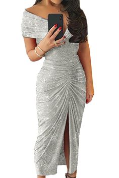 a woman in a silver dress holding a cell phone