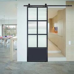 an open sliding glass door in the middle of a room