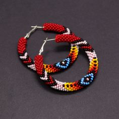 Native Americans inspired beaded hoop earrings. Absolutely eye-catching and very stylish - these earrings make a statement! Will go with any outfit, anytime, anywhere! These earrings are made of Czech seed beads and metal hoops. Hoops are approximately 2" (5cm) in diameter These earrings, whilst large, are lightweight and easy to wear. The hoops have a hinge fastening. The closure allows for peace of mind that you'll never lose an earring whilst it's being worn. A wonderful gift for her on Chris Traditional Handmade Hoop Beaded Earrings, Bohemian Red Hoop Earrings With Colorful Beads, Traditional Small Hoop Beaded Earrings, Traditional Small Hoop Handmade Beaded Earrings, Circular Beaded Earrings For Festivals, Traditional Red Hoop Earrings, Bohemian Hoop Earrings With Large Beads, Traditional Handmade Red Hoop Earrings, Unique Handmade Red Hoop Earrings