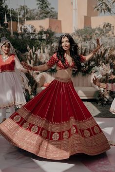 two women in red and white dresses are dancing