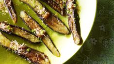 grilled eggplant on a green plate with parmesan sprinkles