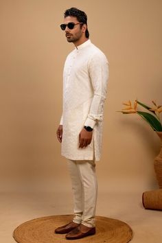 Ivory kurta with all over tone on tone embroidery. Paired with a matching churidar. - Aza Fashions Embroidered Off White Cotton Sherwani, Embroidered Off-white Cotton Sherwani, White Cotton Sherwani With Cutdana, Ceremonial White Kurta With Traditional Fit, Fitted Off White Kurta With Cutdana, Off White Fitted Straight Kurta, Fitted Off White Kurta With Resham Embroidery, Fitted Off-white Kurta With Resham Embroidery, Ceremonial Off White Kurta With Chikankari Embroidery