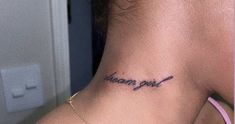 a woman with a tattoo on her neck that says, i am girl in cursive writing