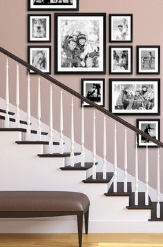 the stairs are lined with black and white pictures