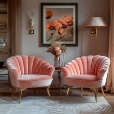 two pink chairs sitting next to each other in a living room