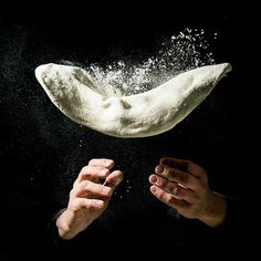 a person is throwing flour into the air