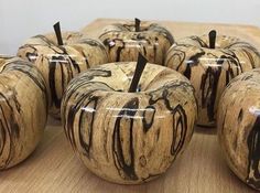 there are many apples that have been carved to look like they're dripping paint