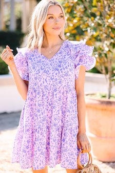 Look your best with our ditsy floral Lavender Purple Babydoll Dress! Enjoy the casual-cute styling that will make heads turn, radiating confidence and feeling your best. Plus, who doesn't love a dress that you can wear with heels or sneakers?! This dress features short ruffled sleeves, a v-neck, babydoll fit, tiered body, and a ditsy floral print. Material has no amount of stretch.Cam is wearing the small. Trendy Purple Short Sleeve Dress, Cute Purple Mini Dress, Trendy Purple Spring Dresses, Cute Flowy Mini Dress For Spring, Cute Pink Mini Dress With Ditsy Floral Print, Lavender Floral Print Cotton Dress, Lavender Cotton Dress With Floral Print, Trendy Ditsy Floral Print Dress For Vacation, Cute Flowy Mini Dress With Ditsy Floral Print