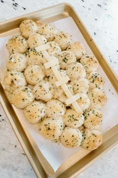 a tray filled with scallops and cheese on top of a marble countertop