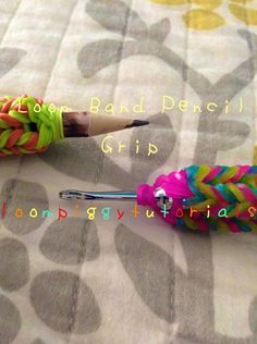 two different colored bracelets on top of a bed next to an open pencil holder