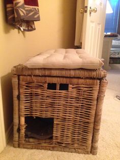 a wicker basket with a cushion on top