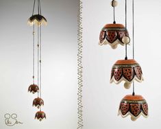 three different types of bells hanging from strings and on the same string, each with an intricate design