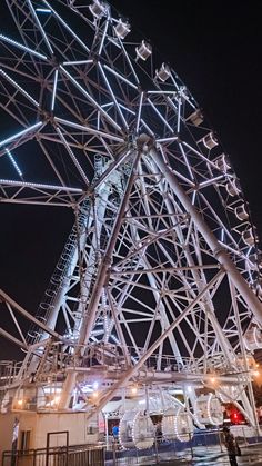 a ferris wheel lit up at night time