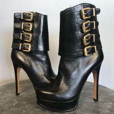 Www.Urbenvibe.Com Details: Beautifully Made Black Platform Booties With 4 Gold Buckles On The Outside Of Ankle And Zip Closure On Inside Of Ankle. Condition: Excellent!!! Approximate Measurements: Heel 5”, Platform 1-1/4” Material: Leather Size: 36-1/2 / 6-1/2” Originally: $1,200 Designer Ankle Moto Boots, Party Boots With Buckle Closure And Almond Toe, Designer Round Toe Boots For Night Out, Designer Platform Boots With Pointed Toe, Luxury Closed Toe Platform Boots, Luxury Closed Toe Boots With Buckle Closure, Designer High Heel Platform Boots, Leather Platform Moto Boots For Party, Party Leather Platform Moto Boots