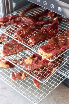 some meat is cooling on a rack in the oven