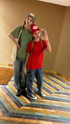 a man and woman taking a selfie in a room with colorful tiles on the floor