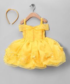 a yellow dress and headband on a hanger