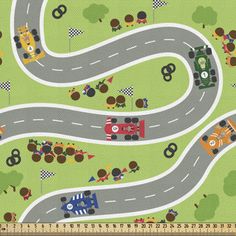 a toy road with cars and trucks on it in the shape of a race track