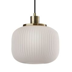 a white and gold pendant light hanging from a ceiling fixture with a black cord attached to it