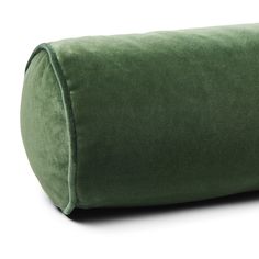 a large green pillow sitting on top of a white floor