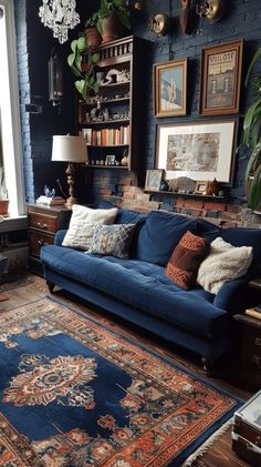 a living room with blue couches and rugs on the floor in front of a window