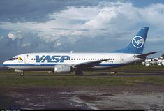 a large jetliner sitting on top of an airport tarmac under a cloudy sky