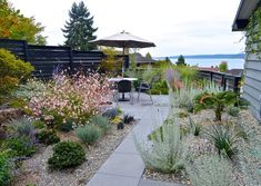 an outdoor patio with flowers and plants surrounding it