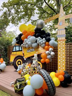 a construction themed birthday party with balloons and decorations on the back of a dump truck