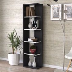 a book shelf with books on it next to a potted plant