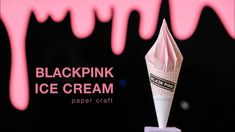 a pink ice cream cone sitting on top of a block of paper with the words blackpink ice cream