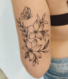 a woman's arm with flowers on it