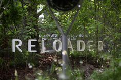 there is a sign that says reloaded in the woods