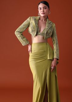 Experience sophistication with our emerald green indo western ensemble. Featuring a citrus green draped skirt and bustier paired with an embroidered short jacket that is delicately ornate with cutdana and elegant sequin accents. Exuding a timeless charm with its flattering silhouette and vibrant color this three-piece outfit evokes a sense of fresh elegance. Dry clean only if required. Slight variation in color is possible due to digital photography. Jacket Indowestern Outfit, Indo Western Outfit From Old Saree, Blazer With Skirt Indian, Indo Western Jackets For Women, Indo Western Skirt Outfits, Skirt With Jacket Outfit, Trending Indo Western Outfits, Indo Western Dress Illustration, Drape Skirts Indo Western