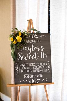 a welcome sign with yellow flowers on it for a wedding ceremony at the fairgrounds