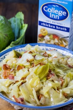 a bowl filled with cabbage and bacon next to a carton of college inn chicken broth