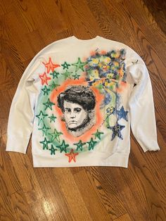 Hand Painted sweater in size men's medium, painted with brush and airbrush with a variety of designs and colours. The sweater fits like a small/medium and is made in Canada.  Please wash cold and hang or flat dry.