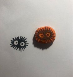 an orange and black object sitting next to each other on top of a white surface