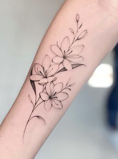 a black and white flower tattoo on the arm