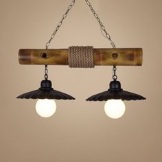 two light fixtures hanging from chains with lights on each end and an attached cord to the ceiling