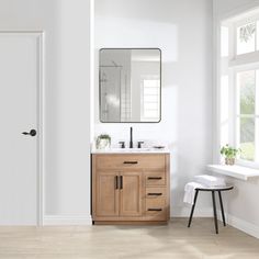 a bathroom with a sink, mirror and stool