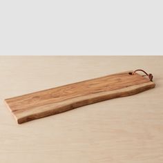 a wooden cutting board sitting on top of a table