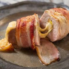 bacon wrapped in cheese and sitting on a plate