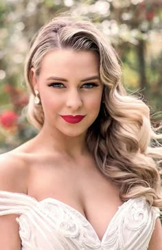 a woman in a white dress with long hair and red lipstick on her lips is posing for the camera