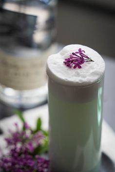 a close up of a cup on a plate with flowers